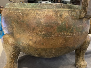 A very large archaic bronze tripod vessel and cover, 'ding', Eastern Zhou period