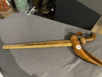 An Indonesian 'kris' or 'keris' dagger in polished Javanese wood with gilt copper and precious stones, 19th C.