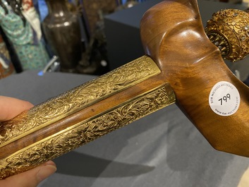 An Indonesian 'kris' or 'keris' dagger in polished Javanese wood with gilt copper and precious stones, 19th C.