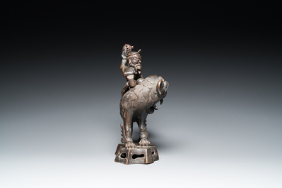 A Chinese bronze censer and cover in the shape of a Luohan on a Buddhist lion, late Ming/early Qing