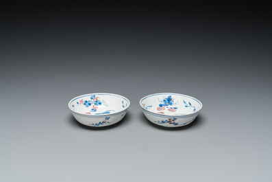 A pair of Chinese blue, white and copper-red semi-eggshell bowls, Xuande mark, Wanli