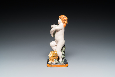 A polychrome Brussels faience sculpture of a putto with a snake standing on a lion, late 18th C.