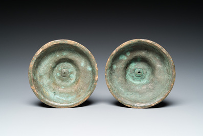 A pair of Italian engraved bronze candlesticks, probably Venice, 16th C.