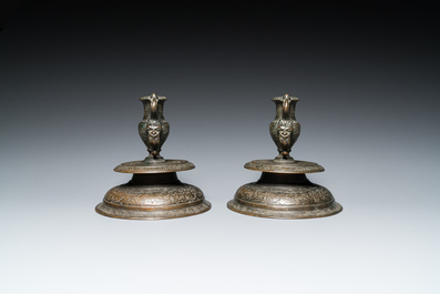 A pair of Italian engraved bronze candlesticks, probably Venice, 16th C.
