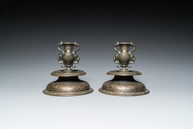 A pair of Italian engraved bronze candlesticks, probably Venice, 16th C.
