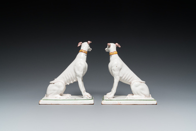 A pair of polychrome Brussels faience greyhounds, 18th C.
