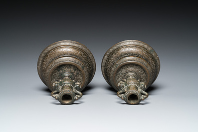 A pair of Italian engraved bronze candlesticks, probably Venice, 16th C.