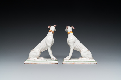 A pair of polychrome Brussels faience greyhounds, 18th C.