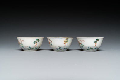 Three Chinese famille rose 'horserider' cups and saucers with the matching tea caddy, Yongzheng/Qianlong