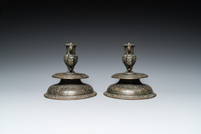 A pair of Italian engraved bronze candlesticks, probably Venice, 16th C.