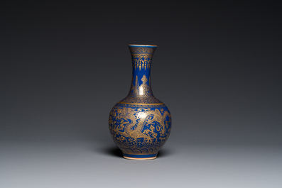 A Chinese monochrome blue gilt-decorated 'dragons' bottle vase, Qianlong mark, 19th C.
