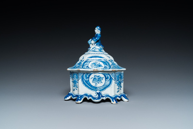 A Dutch Delft blue and white tobacco box with a nobleman holding a roll of tobacco, 2nd half 18th C.