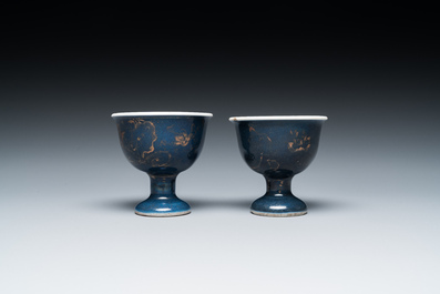 A pair of Chinese powder-blue stem cups with gilt decoration, Kangxi