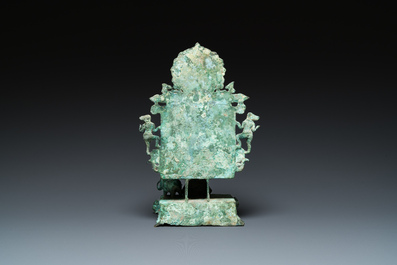 A bronze group with Kubera on a throne, Central Java, Indonesia, 11/12th C.