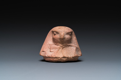 An Egyptian light brown limestone canopic lid in the shape of a falcon head, Late Period