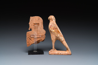 An Egyptian wooden Horus falcon and a fragment of a farao sculpture, Late Period