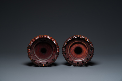 A pair of Chinese monochrome celadon-glazed vases with underglaze design on wooden stands, Qianlong mark, 18/19th C.