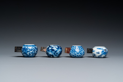 Four Chinese blue, white and copper-red bird feeders, 19th C.