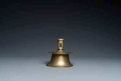 A Flemish brass capstan candlestick, 16th C.