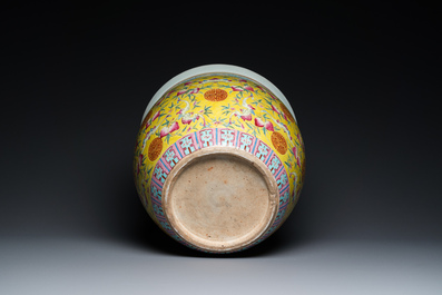A Chinese famille rose yellow-ground fish bowl with bats and peaches, 19th C.