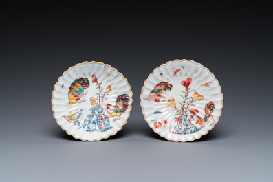 A pair of Chinese famille rose relief-decorated cups and saucers, Yongzheng