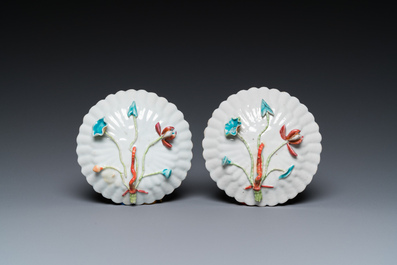 A pair of Chinese famille rose relief-decorated cups and saucers, Yongzheng