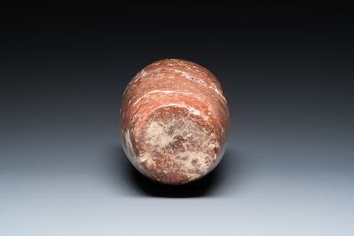 An Egyptian red Breccia jar, Predynastic period, 3500-2900 b.C.