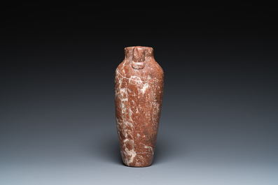An Egyptian red Breccia jar, Predynastic period, 3500-2900 b.C.