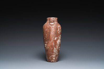 An Egyptian red Breccia jar, Predynastic period, 3500-2900 b.C.