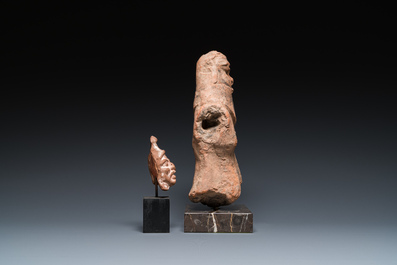 A Roman terracotta sculpture of the god Bes and a grotesque head of a male, ca. 1st C.