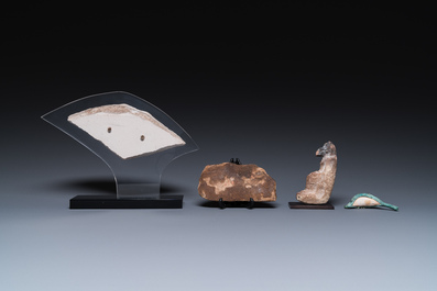 A limestone sculpture of Anubis, two sarcophagus fragments and a fragment of a carved relief, Late period
