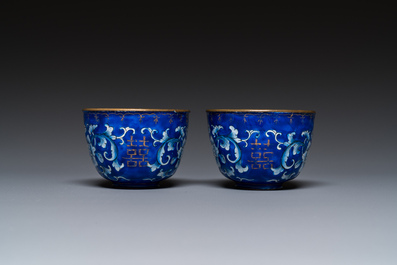 A pair of Chinese Canton enamel trembleuse cups on stands with double 'Shou' design, Qianlong