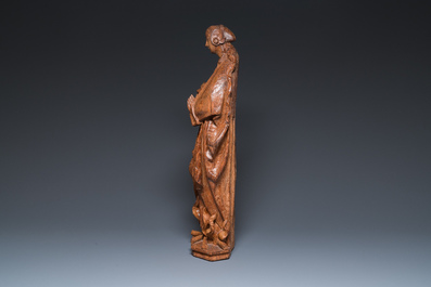 A Flemish carved oak sculpture of a female saint on a pyre, Brabant region, first half 16th C.