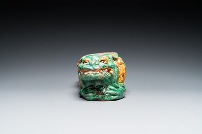 A Chinese sancai-glazed 'three lions' pillow or neck rest, Ming