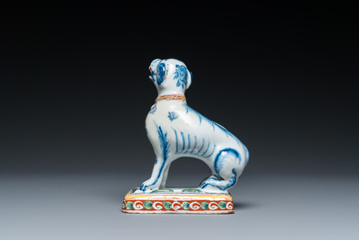A polychrome Dutch Delft dog seated on a plinth, 18th C.