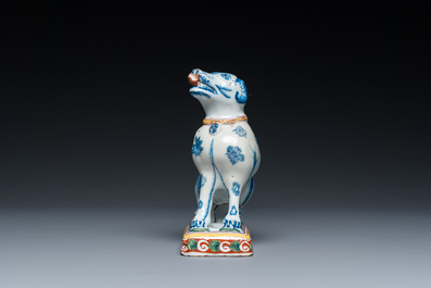 A polychrome Dutch Delft dog seated on a plinth, 18th C.