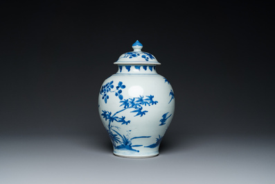 A Chinese blue and white covered vase with birds among blossoming branches, Transitional period