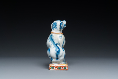 A polychrome Dutch Delft dog seated on a plinth, 18th C.
