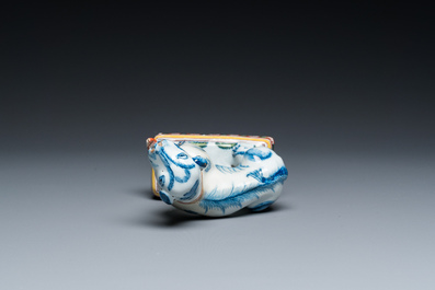 A polychrome Dutch Delft dog seated on a plinth, 18th C.