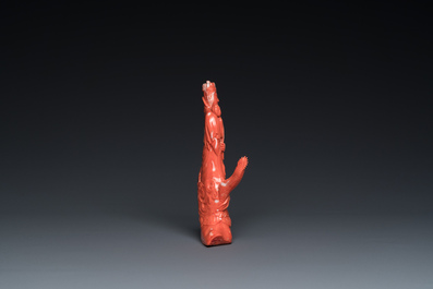 A Chinese red coral group of a standing prince on a dragon, 19/20th C.
