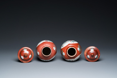 A pair of Chinese famille rose ruby-ground vases and covers, Yongzheng/Qianlong