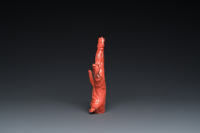 A Chinese red coral group of a standing prince on a dragon, 19/20th C.