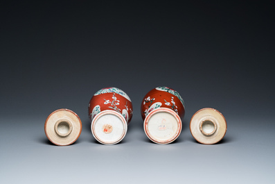 A pair of Chinese famille rose ruby-ground vases and covers, Yongzheng/Qianlong