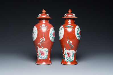 A pair of Chinese famille rose ruby-ground vases and covers, Yongzheng/Qianlong