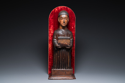 A partly gilded and polychromed wood sculpture of a monk holding a chest, probably Spain, 16th C.