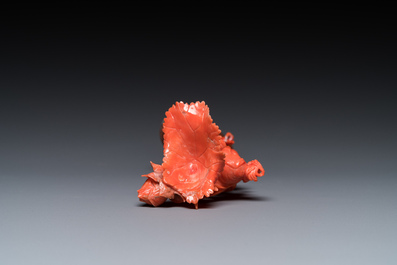 A Chinese red coral figure of a standing lady holding a flower, 19/20th C.