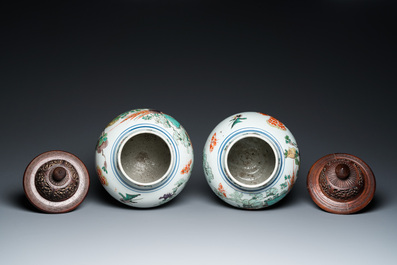 A pair of Chinese famille verte 'pheasant' vases with wooden covers, Kangxi