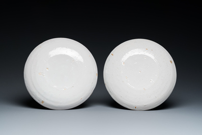 A pair of polychrome Dutch Delft plates depicting grinders, 18th C.