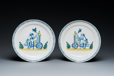A pair of polychrome Dutch Delft plates depicting grinders, 18th C.