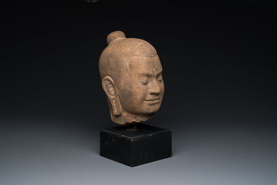 A Khmer stone head of Jayavarman VII in Bayon-style, Cambodia, probably 13th C.